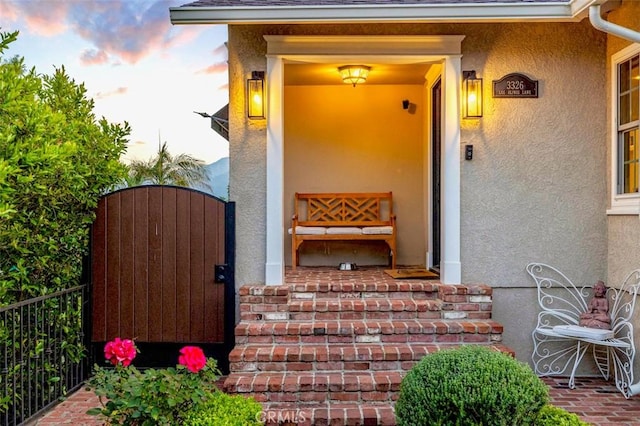 3326 Los Olivos Ln, Glendale, CA 91214 - view of exterior entry with stucco siding, a gate, and a shingled roof