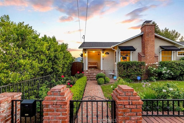 3326 Los Olivos Ln, Glendale, CA 91214 - view of front of house with a gate, stucco siding, and a chimney