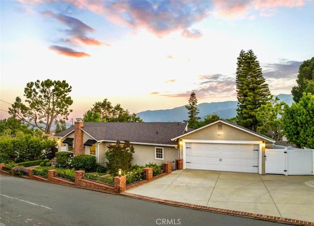 3326 Los Olivos Ln, Glendale, CA 91214 - single story home featuring a gate, a mountain view, stucco siding, and a chimney