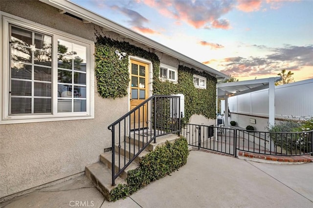 3326 Los Olivos Ln, Glendale, CA 91214 - exterior entry at dusk with stucco siding and a patio area