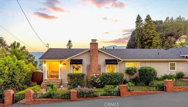 3326 Los Olivos Ln, Glendale, CA 91214 - view of front of house featuring stucco siding, a gate, a fenced front yard, and a chimney