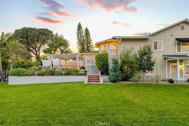 3326 Los Olivos Ln, Glendale, CA 91214 - back of property at dusk with a yard and stucco siding