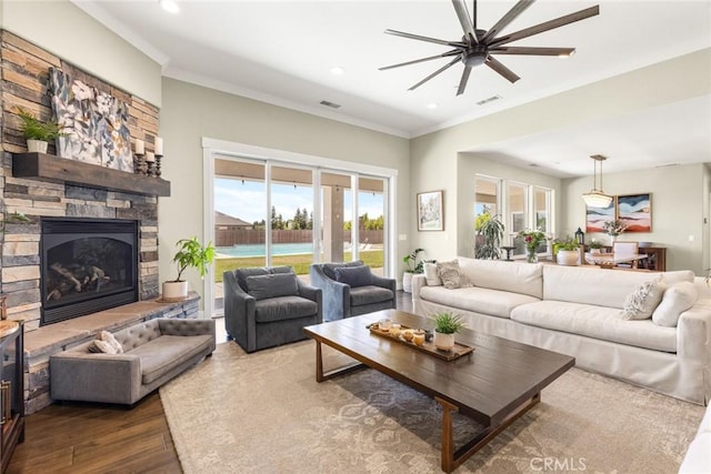 5031 San Juanico Dr, Chico, CA 95973 - living room featuring ceiling fan, dark wood-style flooring, recessed lighting, crown molding, and a fireplace