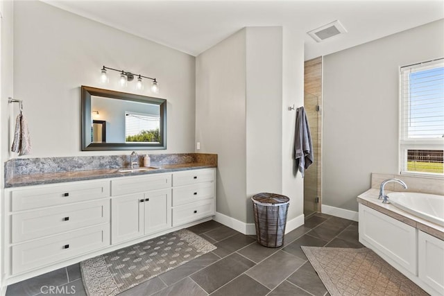 5031 San Juanico Dr, Chico, CA 95973 - full bathroom featuring vanity, a garden tub, a shower stall, and tile patterned flooring