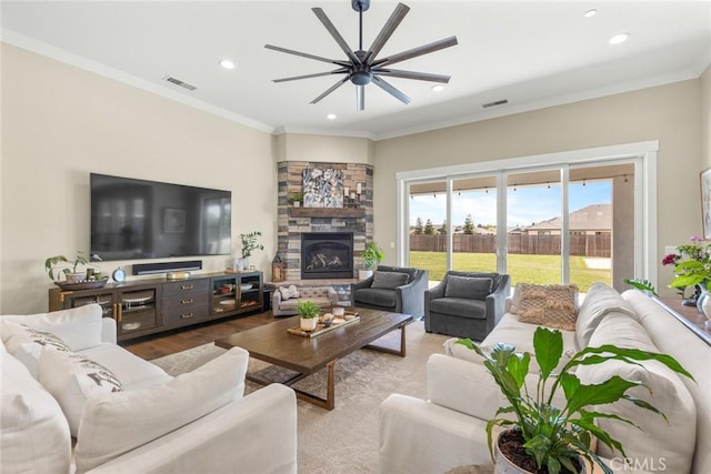 5031 San Juanico Dr, Chico, CA 95973 - living room with a ceiling fan, recessed lighting, a stone fireplace, crown molding, and wood finished floors