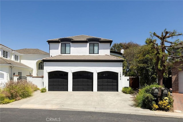 19476 Woodlands Dr, Huntington Beach, CA 92648 - view of front of home featuring a garage, stucco siding, and driveway