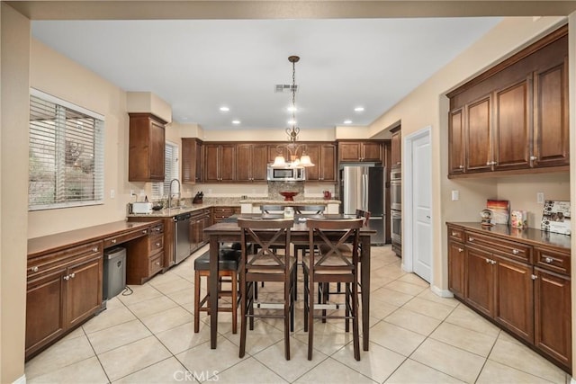 7116 W W Ave L4, Lancaster, CA 93536 - dining room with light tile patterned floors, a chandelier, and recessed lighting