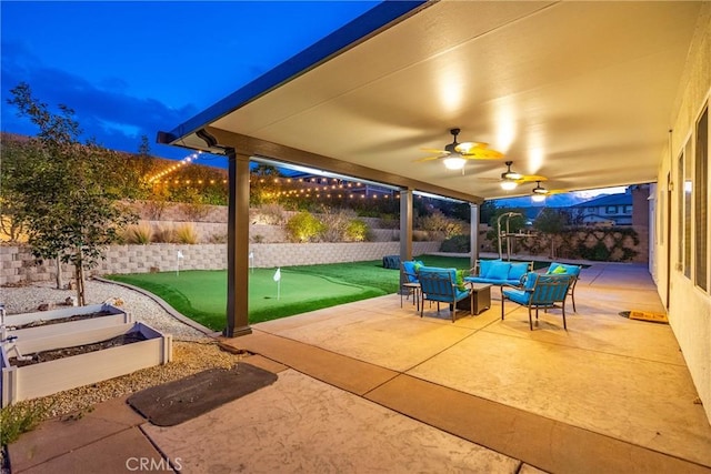 7116 W W Ave L4, Lancaster, CA 93536 - fenced backyard featuring a putting green, a patio area, an outdoor hangout area, and ceiling fan