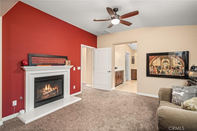 7116 W W Ave L4, Lancaster, CA 93536 - living area featuring ceiling fan, light carpet, a glass covered fireplace, and lofted ceiling