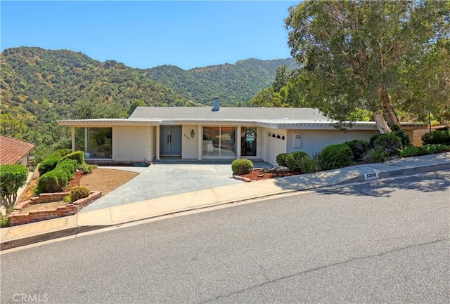 3260 Beaudry, Glendale, CA 91208 - view of front of house featuring a mountain view, an attached garage, driveway, and stucco siding