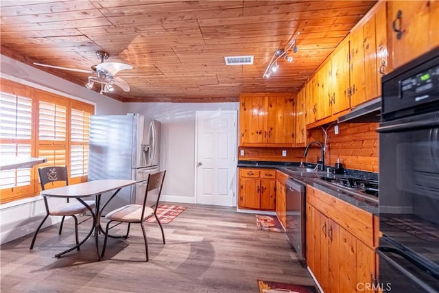4759 Cochran St, Simi Valley, CA 93063 - kitchen featuring stainless steel appliances, wood ceiling, track lighting, dark countertops, and brown cabinetry