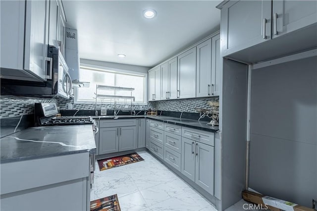4759 Cochran St, Simi Valley, CA 93063 - kitchen with light marble finish floors, stainless steel appliances, decorative backsplash, gray cabinets, and recessed lighting