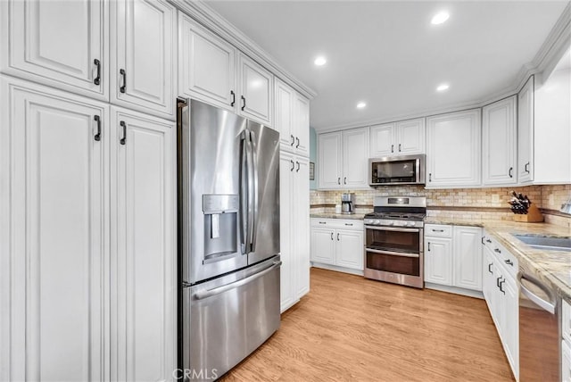 1160 Baseline Rd, La Verne, CA 91750 - kitchen with stainless steel appliances, decorative backsplash, white cabinets, light stone counters, and recessed lighting