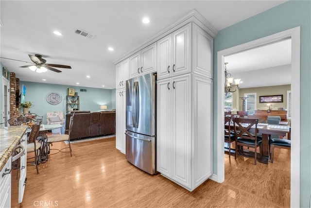 1160 Baseline Rd, La Verne, CA 91750 - kitchen featuring stainless steel refrigerator with ice dispenser, white cabinets, ceiling fan, recessed lighting, and a chandelier