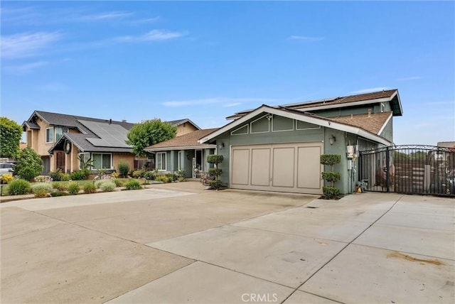 1160 Baseline Rd, La Verne, CA 91750 - view of front of house with driveway, a gate, a garage, and solar panels