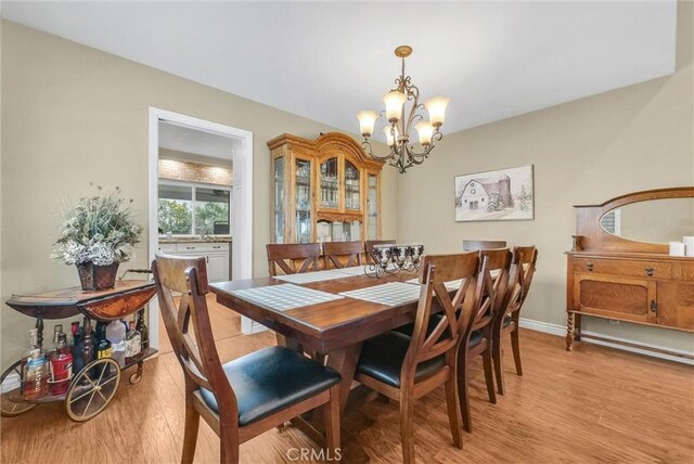 1160 Baseline Rd, La Verne, CA 91750 - dining room with a chandelier and light wood-style flooring