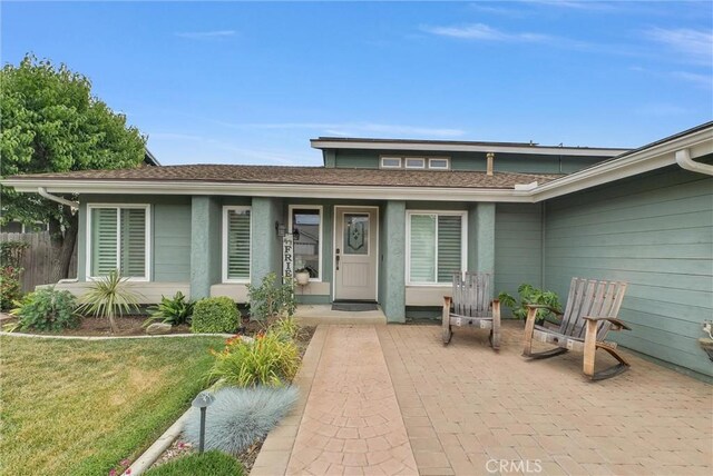 1160 Baseline Rd, La Verne, CA 91750 - entrance to property featuring stucco siding, a shingled roof, and a yard