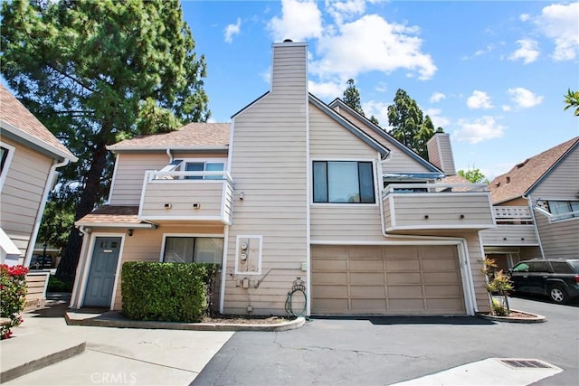 777 Chorro St Unit 3, San Luis Obispo, CA 93401 - view of front of home with a chimney, asphalt driveway, and a garage