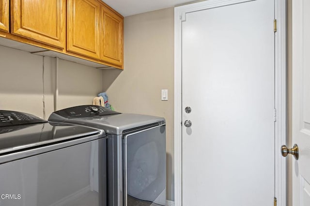 2561 Upper Bay Dr, Oxnard, CA 93036 - laundry room featuring washing machine and dryer and cabinet space