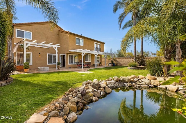 2561 Upper Bay Dr, Oxnard, CA 93036 - rear view of house with a pergola, a fenced backyard, a patio, and stucco siding