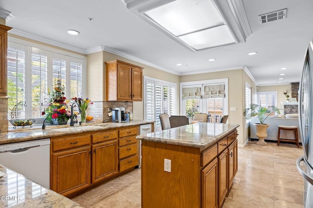 2561 Upper Bay Dr, Oxnard, CA 93036 - kitchen featuring dishwasher, brown cabinets, recessed lighting, tasteful backsplash, and a kitchen island