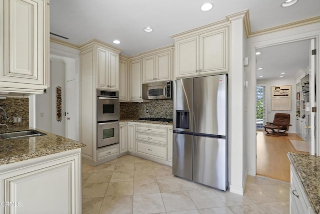 630 S Orange Grove Blvd Unit 5, Pasadena, CA 91105 - kitchen featuring stainless steel appliances, cream cabinets, backsplash, stone countertops, and recessed lighting