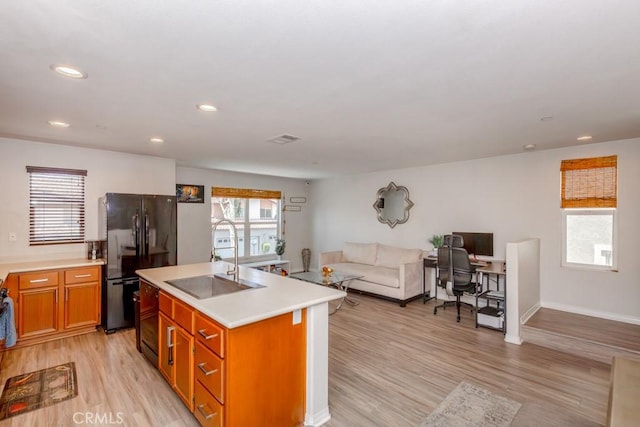 13015 New Hvn, Riverside, CA 92503 - kitchen with freestanding refrigerator, open floor plan, light wood-type flooring, light countertops, and recessed lighting