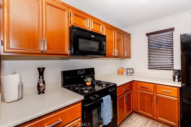 13015 New Hvn, Riverside, CA 92503 - kitchen featuring black appliances, light countertops, brown cabinetry, and light wood-type flooring