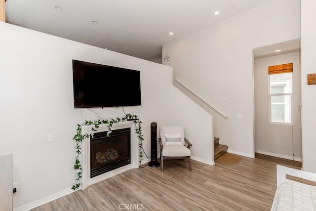 13015 New Hvn, Riverside, CA 92503 - living room with light wood finished floors, stairway, and recessed lighting