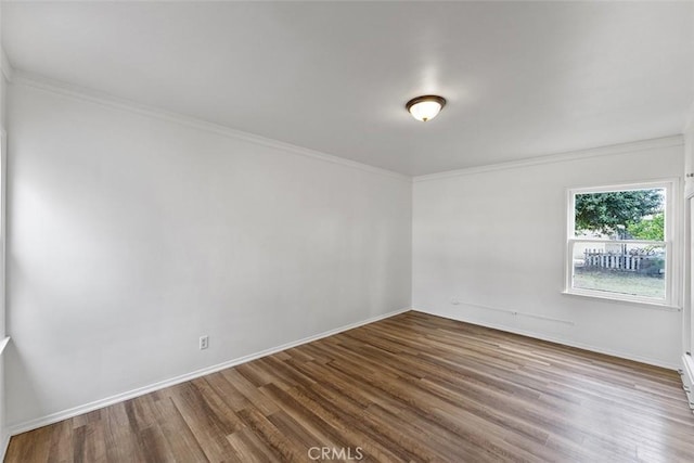 11749 Clarkman St, Santa Fe Springs, CA 90670 - spare room with wood finished floors and ornamental molding
