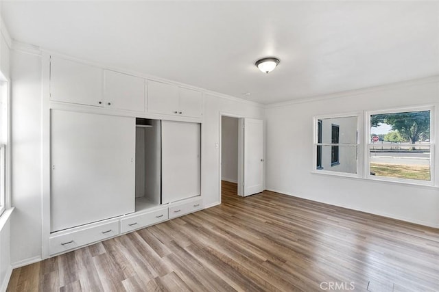 11749 Clarkman St, Santa Fe Springs, CA 90670 - unfurnished bedroom with light wood-style floors, ornamental molding, and a closet