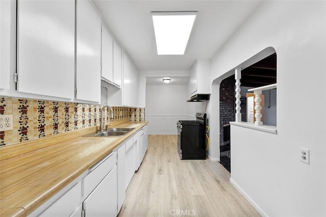 11749 Clarkman St, Santa Fe Springs, CA 90670 - kitchen featuring gas range oven, light wood-style flooring, white cabinetry, tasteful backsplash, and light countertops