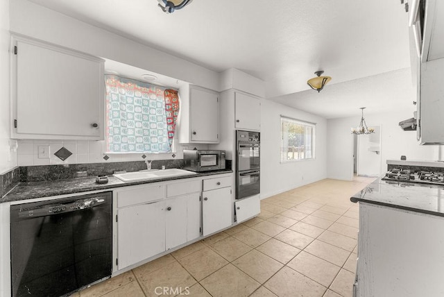 10527 S Wilton Pl, Los Angeles, CA 90047 - kitchen featuring black appliances, white cabinetry, a chandelier, backsplash, and light tile patterned floors