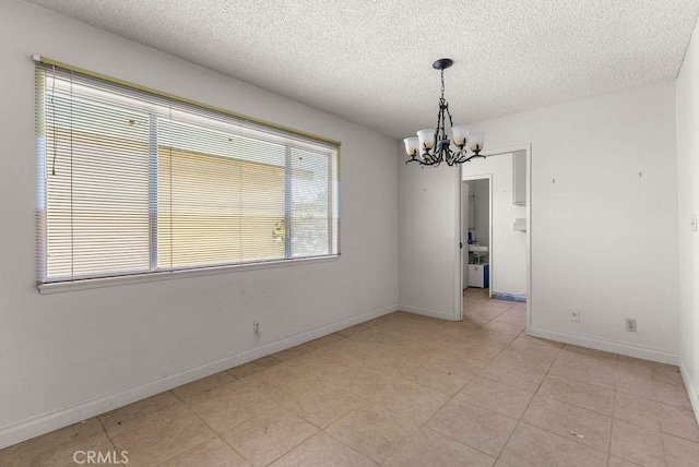10527 S Wilton Pl, Los Angeles, CA 90047 - empty room with a chandelier, a textured ceiling, and light tile patterned flooring