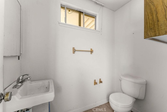 10527 S Wilton Pl, Los Angeles, CA 90047 - half bath featuring a sink and tile patterned flooring