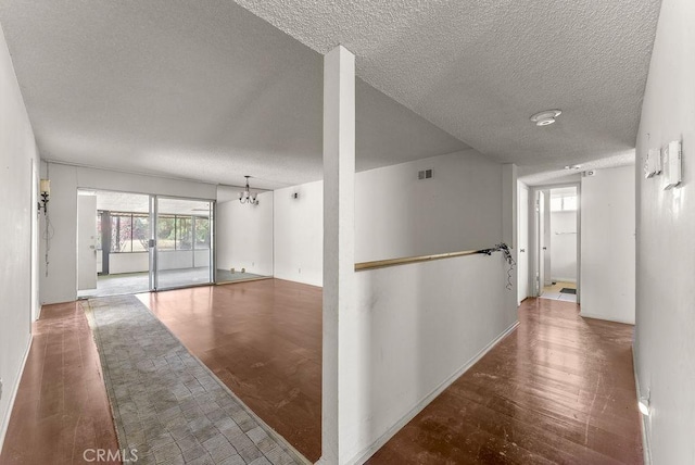 10527 S Wilton Pl, Los Angeles, CA 90047 - hall with a textured ceiling and wood finished floors