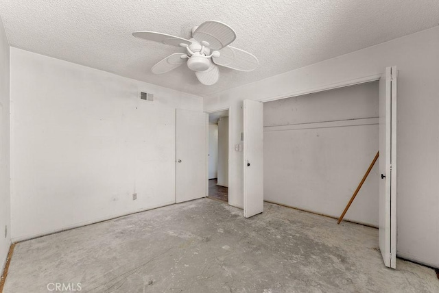 10527 S Wilton Pl, Los Angeles, CA 90047 - unfurnished bedroom with unfinished concrete floors, ceiling fan, a closet, and a textured ceiling