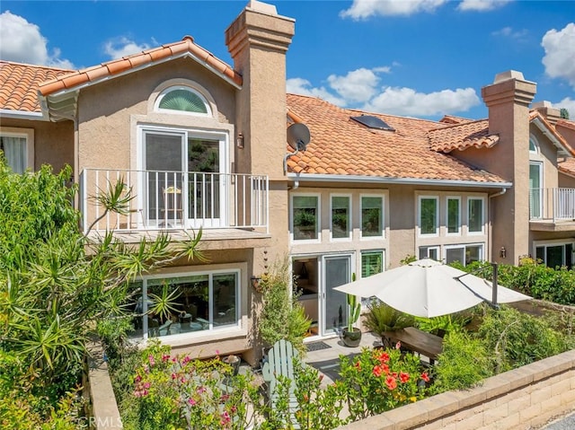 29411 Port Royal Way, Laguna Niguel, CA 92677 - back of house featuring a balcony, a tiled roof, a chimney, and stucco siding