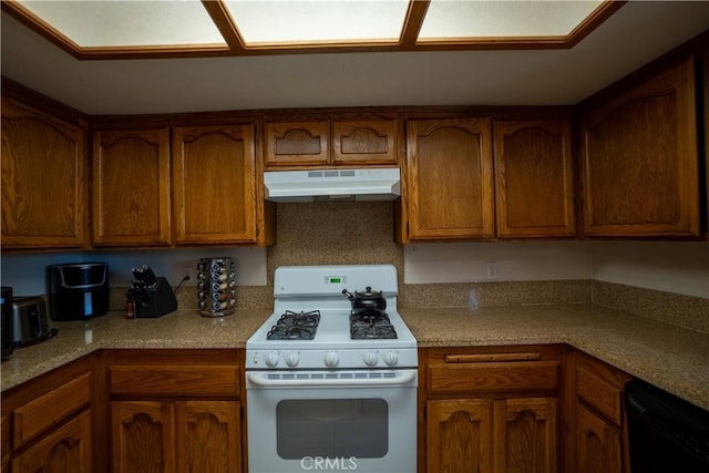 7681 Newhall Ave, Hesperia, CA 92345 - kitchen featuring gas range gas stove, under cabinet range hood, dishwasher, brown cabinets, and light countertops