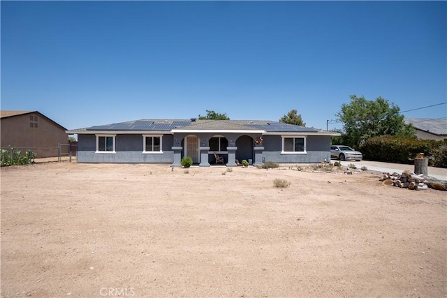 7681 Newhall Ave, Hesperia, CA 92345 - view of front facade featuring roof mounted solar panels, covered porch, and stucco siding