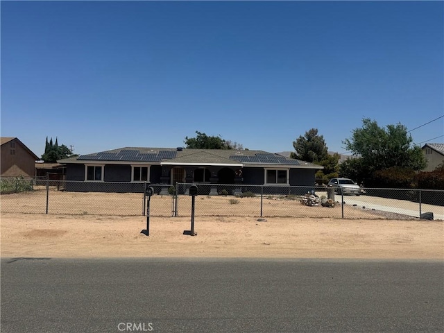 7681 Newhall Ave, Hesperia, CA 92345 - view of front facade featuring solar panels and a fenced front yard