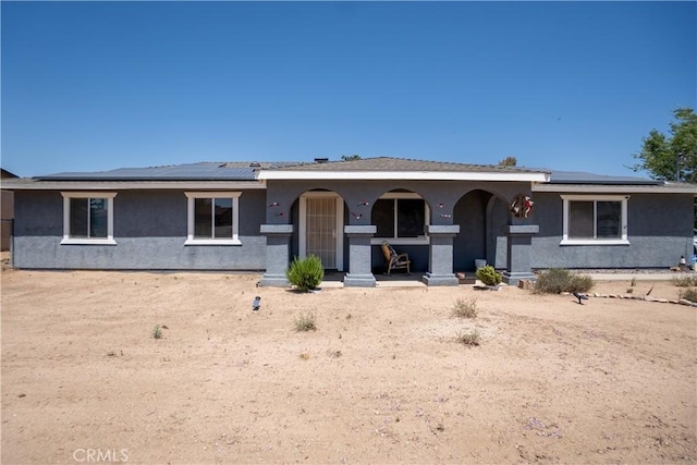 7681 Newhall Ave, Hesperia, CA 92345 - view of front facade with a porch, stucco siding, and roof mounted solar panels