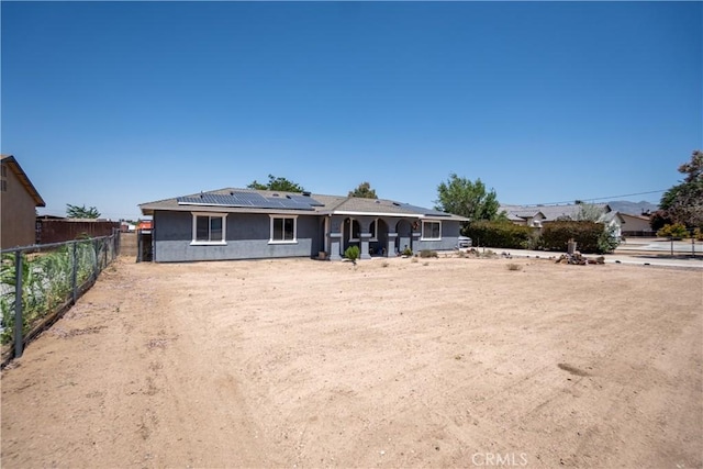 7681 Newhall Ave, Hesperia, CA 92345 - rear view of property with roof mounted solar panels and stucco siding