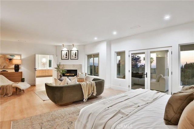 1257 Fetlock Way, Riverside, CA 92506 - bedroom featuring access to outside, a fireplace, light wood-style floors, recessed lighting, and french doors