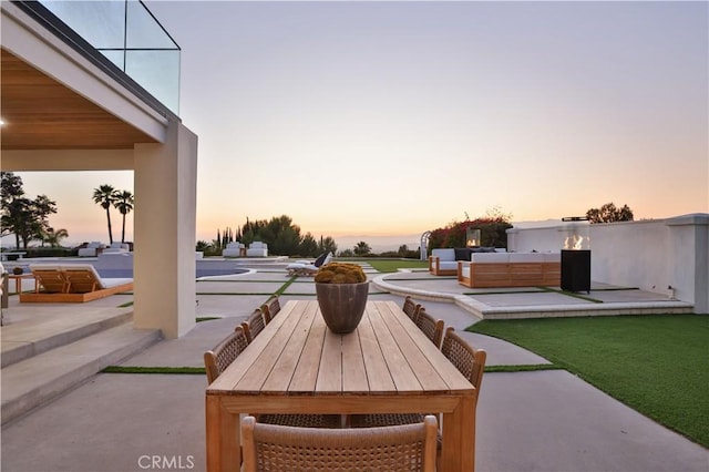 1257 Fetlock Way, Riverside, CA 92506 - patio terrace at dusk with a patio area, an outdoor living space, and outdoor dining space