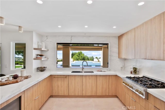 1257 Fetlock Way, Riverside, CA 92506 - kitchen with stainless steel gas stovetop, light brown cabinets, modern cabinets, recessed lighting, and light stone counters