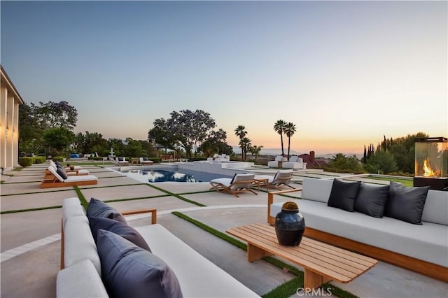 1257 Fetlock Way, Riverside, CA 92506 - patio terrace at dusk featuring an outdoor hangout area, a patio area, and an outdoor pool
