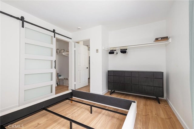 5910 Rancho Mission Rd Unit 27, San Diego, CA 92108 - bedroom with wood finished floors, a barn door, and a closet