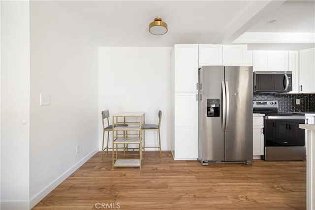 5910 Rancho Mission Rd Unit 27, San Diego, CA 92108 - kitchen featuring stainless steel appliances, decorative backsplash, white cabinetry, light wood-style flooring, and light countertops