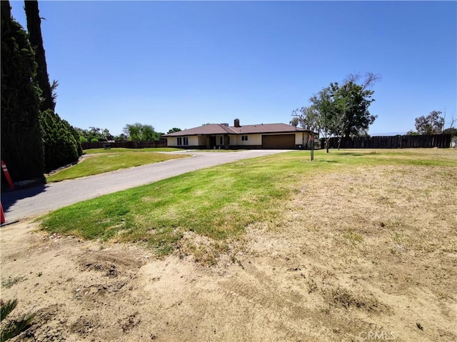 7519 Man O War St, Bakersfield, CA 93307 - view of front facade featuring a garage and driveway